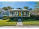 Charming home featuring a beautifully landscaped yard and inviting covered porch with a bright yellow front door at 428 Highland Ave, Orlando, FL 32801