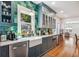 Modern kitchen featuring vibrant green backsplash, stylish cabinetry, stainless steel appliances, and hardwood floors at 428 Highland Ave, Orlando, FL 32801