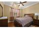 Cozy bedroom featuring vaulted ceiling, ceiling fan, neutral walls, and a zebra-striped comforter set at 4414 Azure Isle Way, Kissimmee, FL 34744