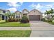 Beautiful two-story home featuring a manicured lawn and colorful landscaping at 4414 Azure Isle Way, Kissimmee, FL 34744