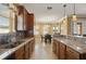 Kitchen with granite countertops, wooden cabinets, and a breakfast nook with many windows at 4414 Azure Isle Way, Kissimmee, FL 34744