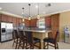 Well-equipped kitchen with stainless steel appliances, granite countertops, and a breakfast bar with seating at 4414 Azure Isle Way, Kissimmee, FL 34744