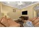 Living room featuring light yellow walls, white ceiling, fan, flat screen tv and comfortable seating at 4414 Azure Isle Way, Kissimmee, FL 34744