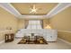 Spacious living room featuring a coffered ceiling, neutral paint and a comfortable white sofa at 4414 Azure Isle Way, Kissimmee, FL 34744