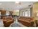 Open-concept living area with a view into the kitchen and dining space, plus comfortable leather seating at 4414 Azure Isle Way, Kissimmee, FL 34744