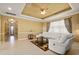 Spacious living room with tray ceiling, ceiling fan, and a comfortable white sectional sofa at 4414 Azure Isle Way, Kissimmee, FL 34744