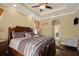 Primary bedroom featuring ceiling detail, ceiling fan, and private access to the bathroom at 4414 Azure Isle Way, Kissimmee, FL 34744