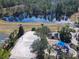 Aerial view of a community with a sand volleyball court and playground near a pond at 601 Orange Cosmos Blvd, Davenport, FL 33837