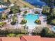 Overhead view of a resort-style community pool with seating areas and lush landscaping at 601 Orange Cosmos Blvd, Davenport, FL 33837