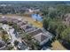 Aerial view of homes backing onto a pond with lush green trees around the community at 601 Orange Cosmos Blvd, Davenport, FL 33837