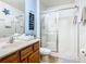 A bathroom features a vanity with a sink, a toilet, and a walk-in shower with glass doors at 601 Orange Cosmos Blvd, Davenport, FL 33837