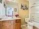 Bright bathroom features a shower/tub, toilet, and vanity with a large mirror at 601 Orange Cosmos Blvd, Davenport, FL 33837