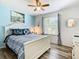 A cozy bedroom featuring blue hues, nautical accents, and a sunny window with striped curtains at 601 Orange Cosmos Blvd, Davenport, FL 33837