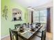 Elegant dining room featuring a set table, stylish lighting, and view of a living area at 601 Orange Cosmos Blvd, Davenport, FL 33837