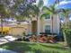 Charming two-story home featuring a well-manicured lawn, mature landscaping, and a welcoming entrance at 601 Orange Cosmos Blvd, Davenport, FL 33837