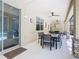 Covered patio featuring a table and chairs with a ceiling fan and stone column accents at 601 Orange Cosmos Blvd, Davenport, FL 33837