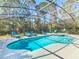 Relaxing screened-in pool area with comfortable lounge chairs and spa at 601 Orange Cosmos Blvd, Davenport, FL 33837