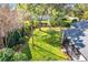 Overhead view of the green backyard showcasing mature trees and manicured flower beds at 6244 Little Lake Sawyer Dr, Windermere, FL 34786