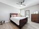 Bedroom with stylish bed frame, modern lighting, and wood-look flooring at 6244 Little Lake Sawyer Dr, Windermere, FL 34786