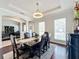 Bright dining room with a tray ceiling, large windows, and a view to an office at 6244 Little Lake Sawyer Dr, Windermere, FL 34786