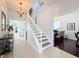 Welcoming foyer with tile floors, a staircase, and views into the adjacent living spaces at 6244 Little Lake Sawyer Dr, Windermere, FL 34786