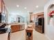 Spacious kitchen showcasing stainless steel appliances, wood cabinets, and a rolling kitchen island at 6244 Little Lake Sawyer Dr, Windermere, FL 34786