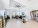 Comfortable living room featuring a tray ceiling, a sectional sofa, and neutral decor at 6244 Little Lake Sawyer Dr, Windermere, FL 34786