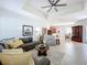 Comfortable living room featuring tile floors, a ceiling fan, neutral paint, and an open floor plan at 6244 Little Lake Sawyer Dr, Windermere, FL 34786