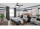 A bedroom with a ceiling fan, dark blue decorative paint, and a wooden bed frame at 7062 Rosy Sky Ave, Orlando, FL 32829