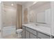 Elegant bathroom with a large mirror, gray vanity, and a shower-tub combination with stylish decor at 7094 Rosy Sky Ave, Orlando, FL 32829