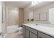 Elegant bathroom featuring double sinks, quartz countertop, and tiled shower at 7094 Rosy Sky Ave, Orlando, FL 32829