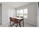 Bright dining area features a modern table with chairs, complemented by a window and closet space at 7094 Rosy Sky Ave, Orlando, FL 32829