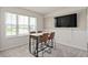 Cozy dining area with modern table, chairs, and a TV for entertainment at 7094 Rosy Sky Ave, Orlando, FL 32829