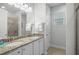 Bathroom featuring double sinks with granite counters and modern fixtures at 7659 Wilmington Loop, Kissimmee, FL 34747