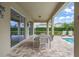 Outdoor patio with dining table and lounge chairs, overlooking the pool and landscaping at 7659 Wilmington Loop, Kissimmee, FL 34747