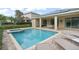 Enjoy the poolside lounging around this pool and spa with covered patio and solar panels above at 7659 Wilmington Loop, Kissimmee, FL 34747