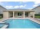 Enjoy the poolside lounging and outdoor dining around this pool and spa with solar panels above at 7659 Wilmington Loop, Kissimmee, FL 34747