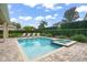 Enjoy this private pool and spa, surrounded by brick pavers and lush greenery for a serene outdoor experience at 7659 Wilmington Loop, Kissimmee, FL 34747