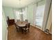 Bright dining room with natural light, modern chandelier, and hardwood floors at 802 Rosa St, Celebration, FL 34747