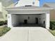 Spacious two-car garage featuring ample storage space, a side door, and clean concrete flooring at 802 Rosa St, Celebration, FL 34747