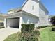 Attached garage exterior showing access to the driveway and landscaped garden at 802 Rosa St, Celebration, FL 34747