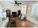 Open-concept living room with hardwood floors, white sofa, and a cozy armchair at 802 Rosa St, Celebration, FL 34747