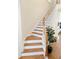 Staircase with wooden steps and white risers leading to the upper level at 802 Rosa St, Celebration, FL 34747