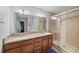 Bathroom featuring a double vanity with modern fixtures and a tiled shower at 825 Agnes Dr, Altamonte Springs, FL 32701