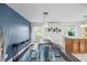 Stylish dining area with modern decor, blue accent wall, and view of the kitchen at 825 Agnes Dr, Altamonte Springs, FL 32701