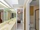 Bathroom featuring double sinks, a big mirror, and a doorway view into the main bedroom at 871 Cynthianna Cir, Altamonte Springs, FL 32701