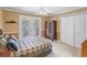 Relaxing bedroom boasts French doors, a spacious closet, and neutral wall-to-wall carpet at 871 Cynthianna Cir, Altamonte Springs, FL 32701