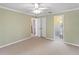 Bright bedroom featuring neutral carpeting, ceiling fan, and views of a private bathroom at 871 Cynthianna Cir, Altamonte Springs, FL 32701