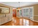 Dining room with glass table, chandelier, bay window and hardwood floors at 871 Cynthianna Cir, Altamonte Springs, FL 32701