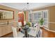 Dining room with glass table, chandelier, bay window and hardwood floors at 871 Cynthianna Cir, Altamonte Springs, FL 32701